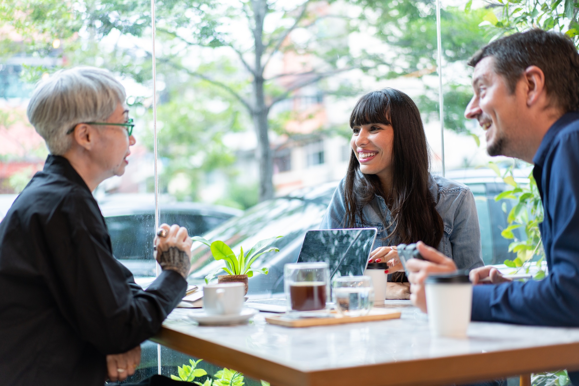 Business sales team have meeting with senior woman in the coffee shop